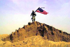 Military Person with Flag on Sand